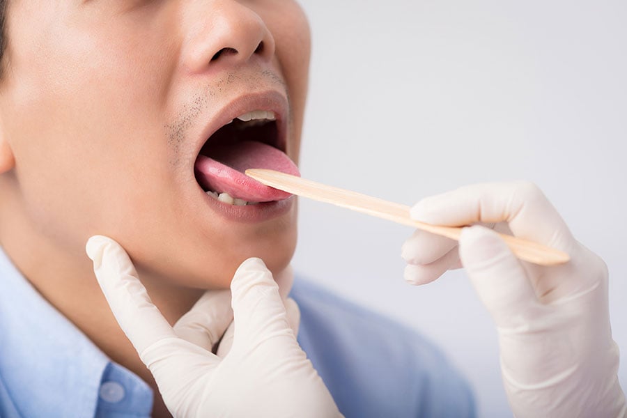 Mouth exam using tongue depressor